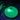 A Meridian Discs Current disc golf disc glowing bright green under UV light, with a hand holding a black UV lamp on the left.